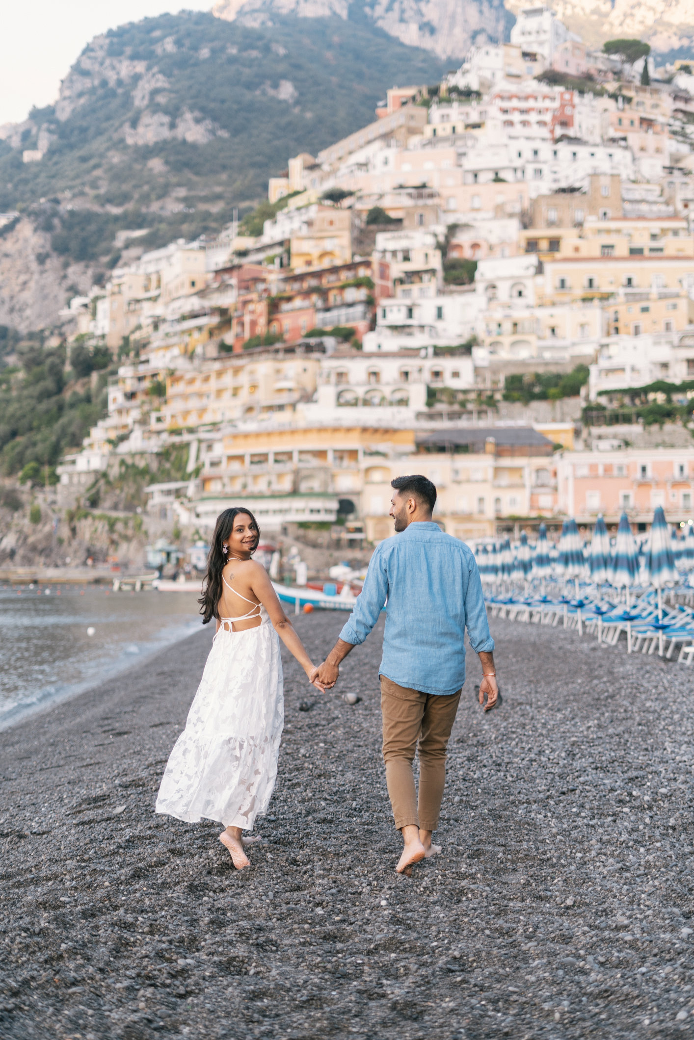 Couple strolling through Spiagga grande in Positano