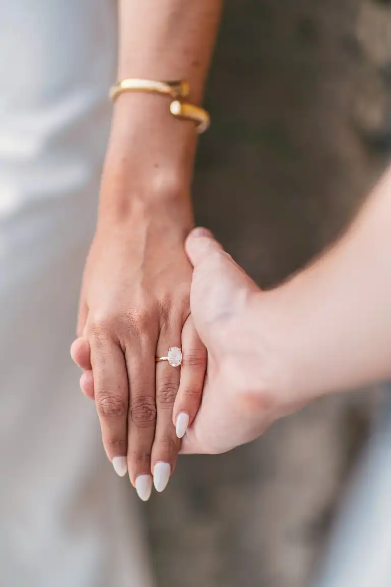 two people holding hands showcasing a proposal ring in Positano