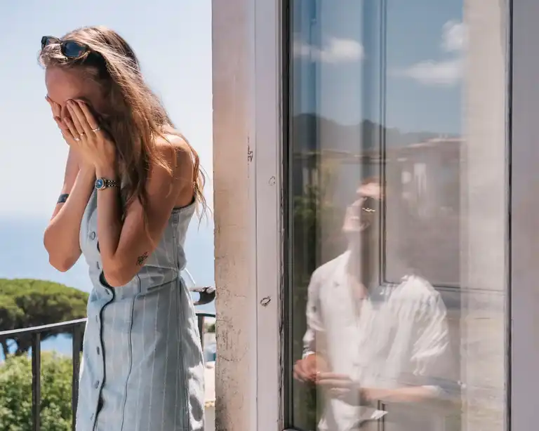 Photo showing a guy proposing to his girlfriend, it's a creative photo that showcase both while he is displayed in the window reflection next to her girlfriend which is in shock for the sudden wedding proposal