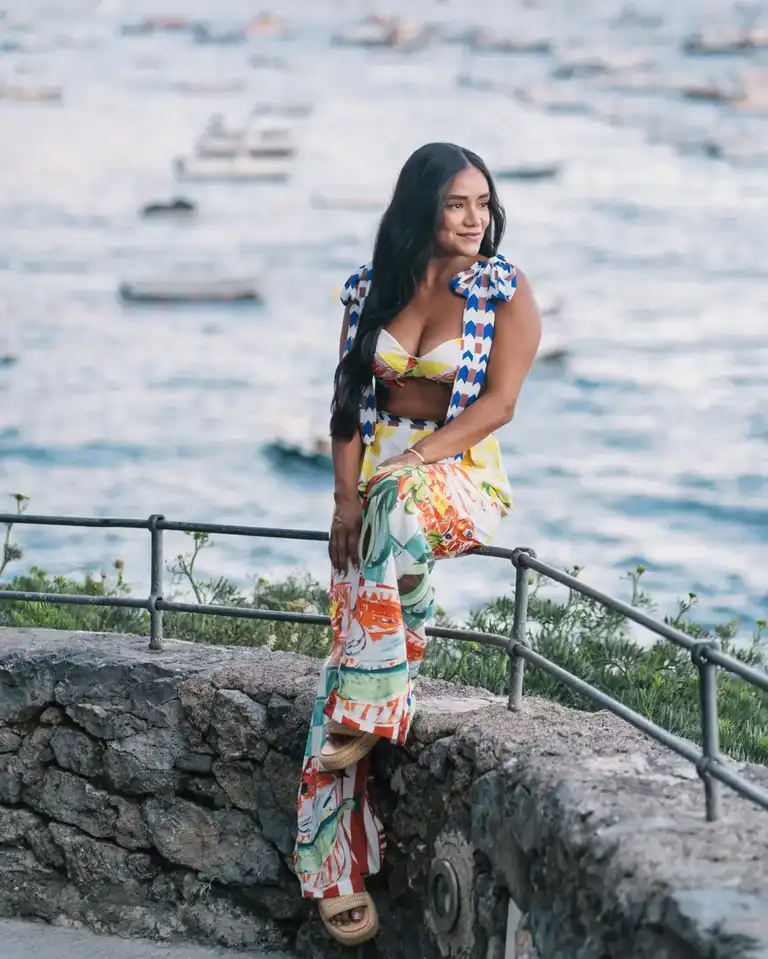Girl wearing colorful dress with pants and bikini in Positano
