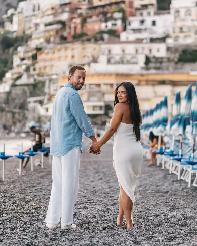 Couple in Positano by Spiaggia grande holding hands together