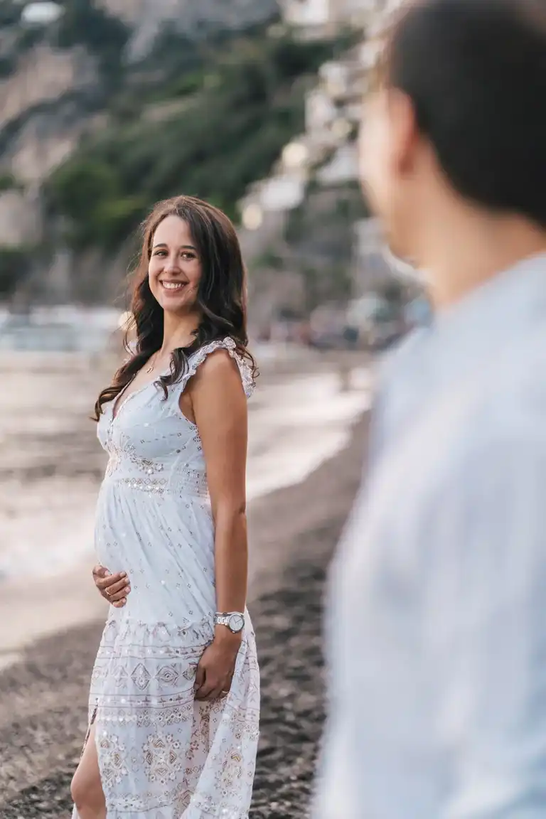 Pregnant woman looking at her husband blurried in the foreground smiling at him