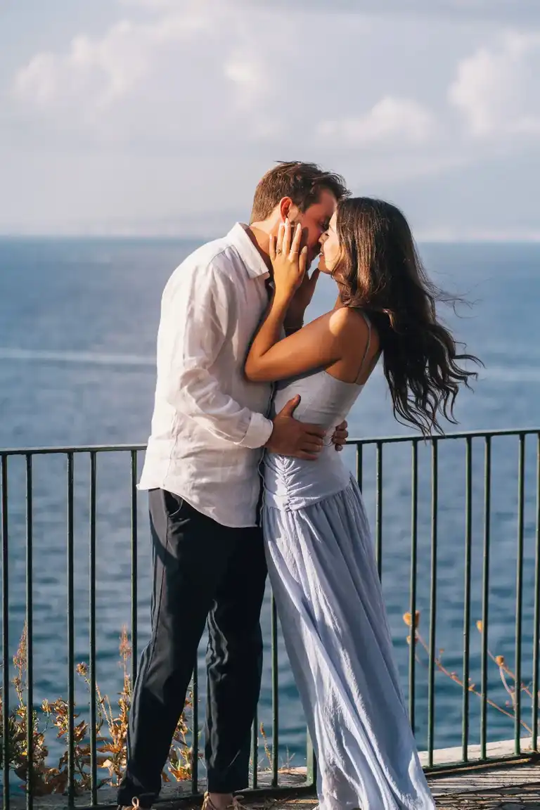 Couple kissing romantically after he proposed to his girlfriend in Sorrento