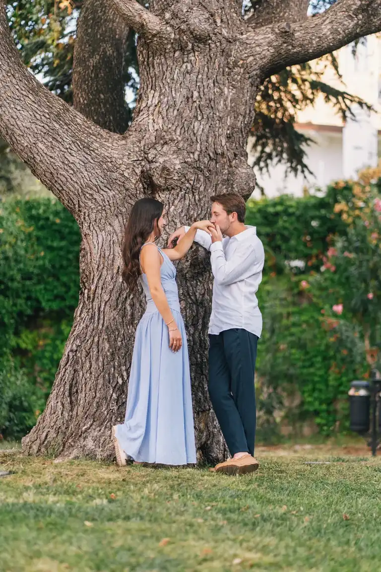 Man Kissing her fiancé hand as a gentleman in the garden overlooking the Villa Comunale in Sorrento