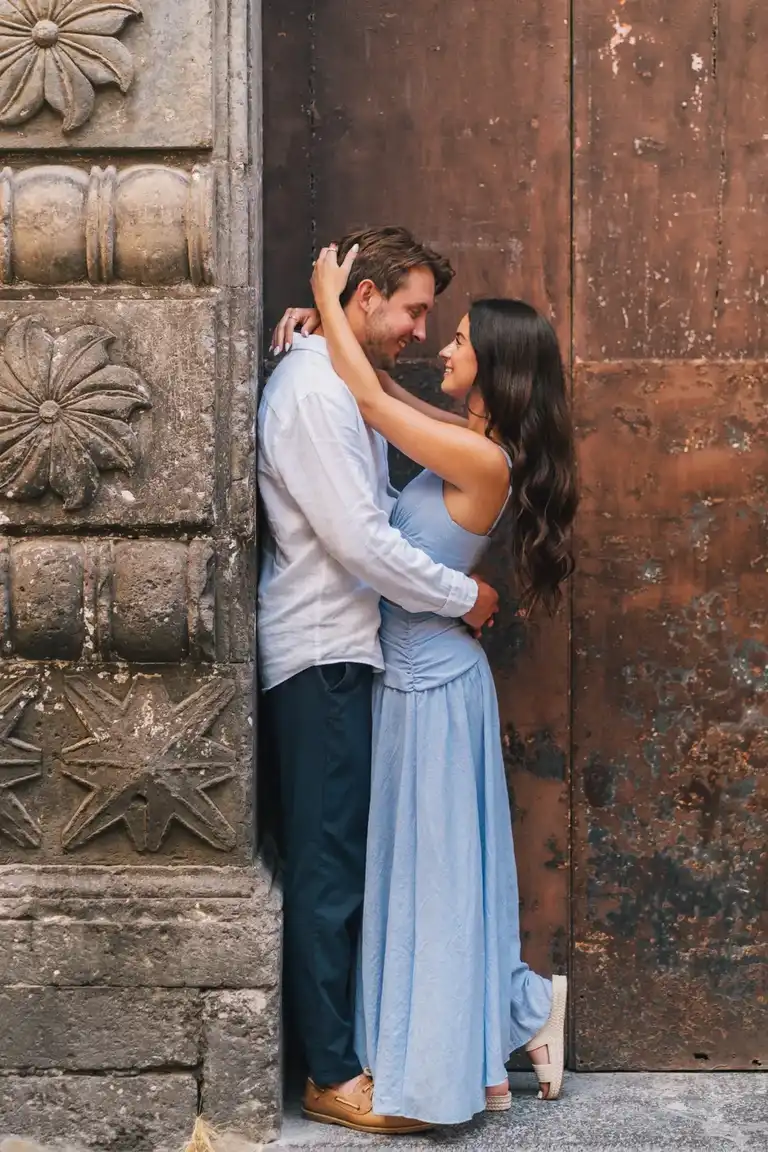 Couple kissing by an old door in the city centre of Sorrento for a couple photoshoot