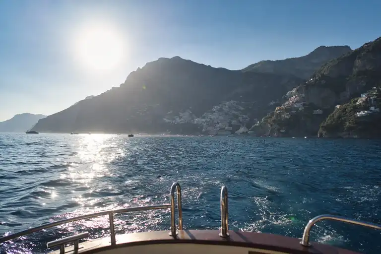View of Positano from boat at sunset