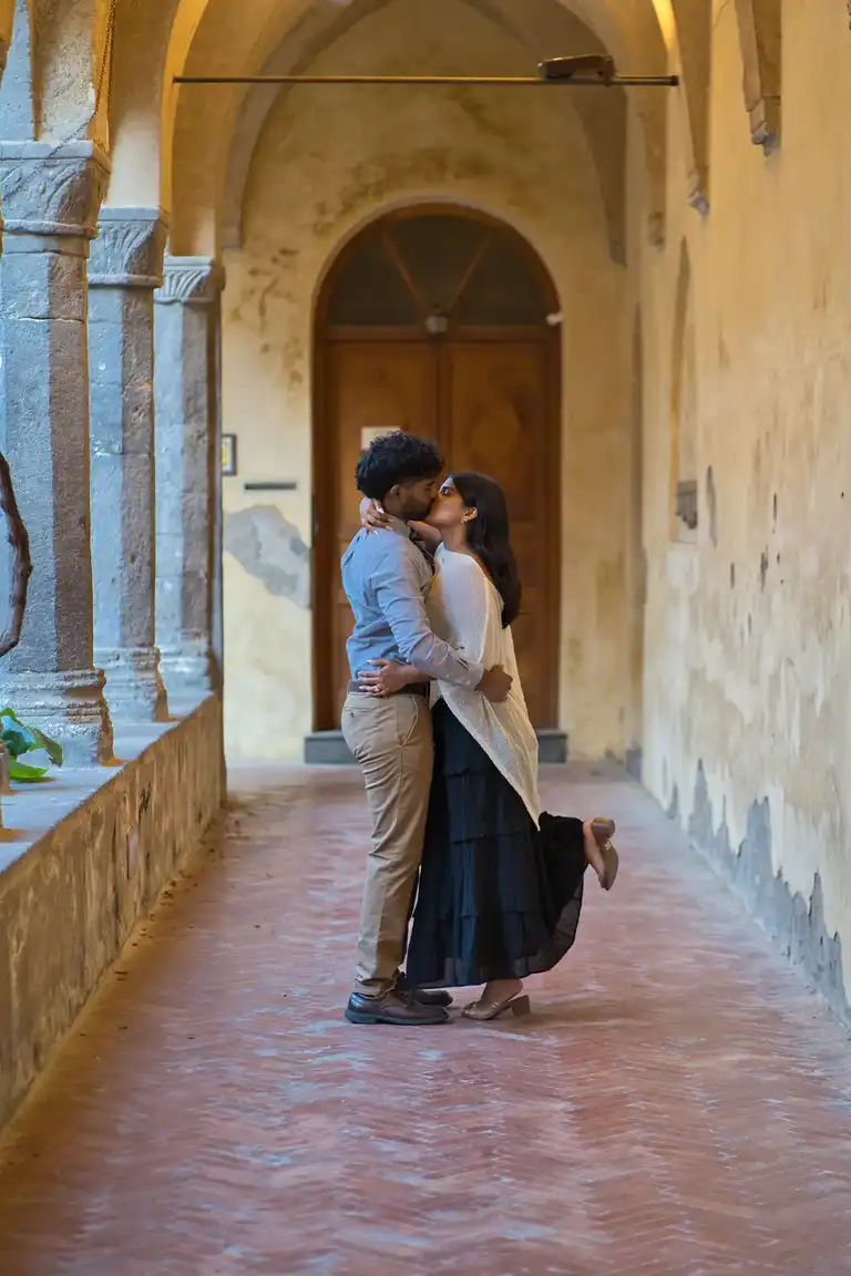 Couple kissing under the arches of the cloister of San Francesco in Sorrento