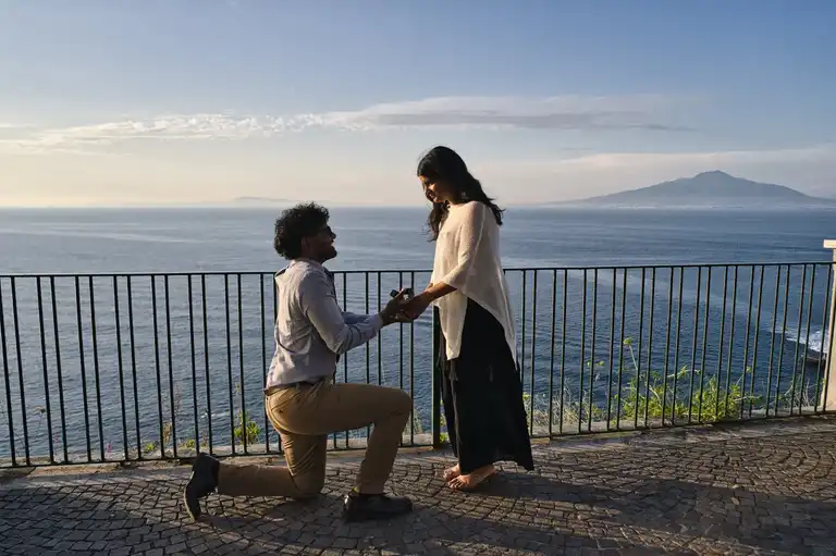 Man proposing on his knee on the balcony of Villa Comunale in Sorrento