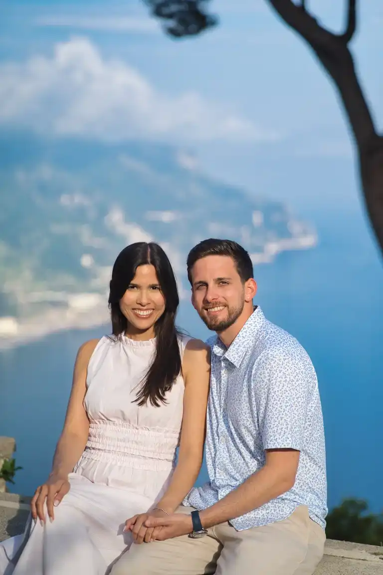 Couple smiling for the camera after the proposal sitting on the terrace of Villa Rufolo