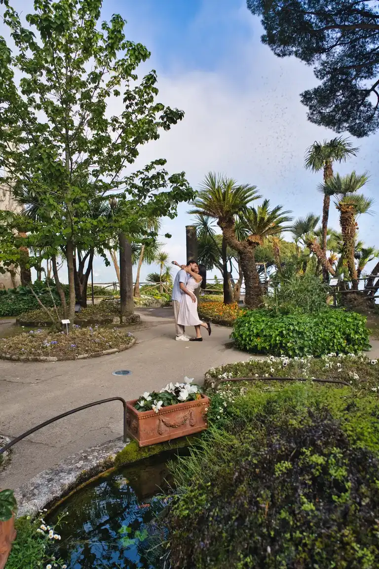 Couple just proposed dancing in the luscious gardens of Villa Rufolo in Ravello