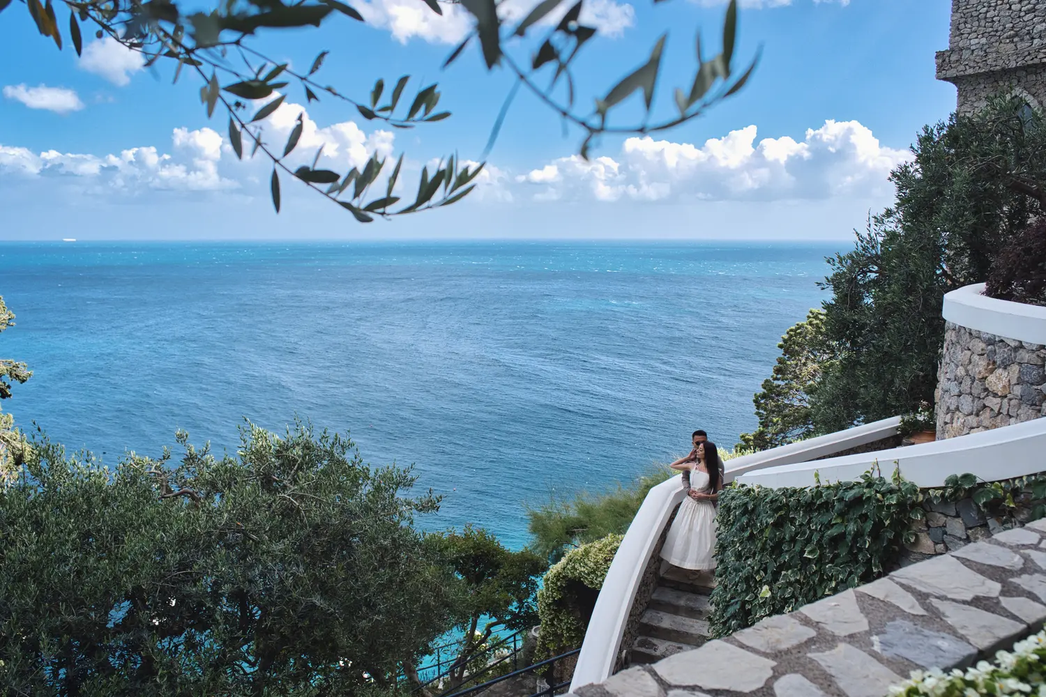 Newlyweds embracing on the panoramic terrace overlooking the sea at Borgo Sant'Andrea near Amalfi