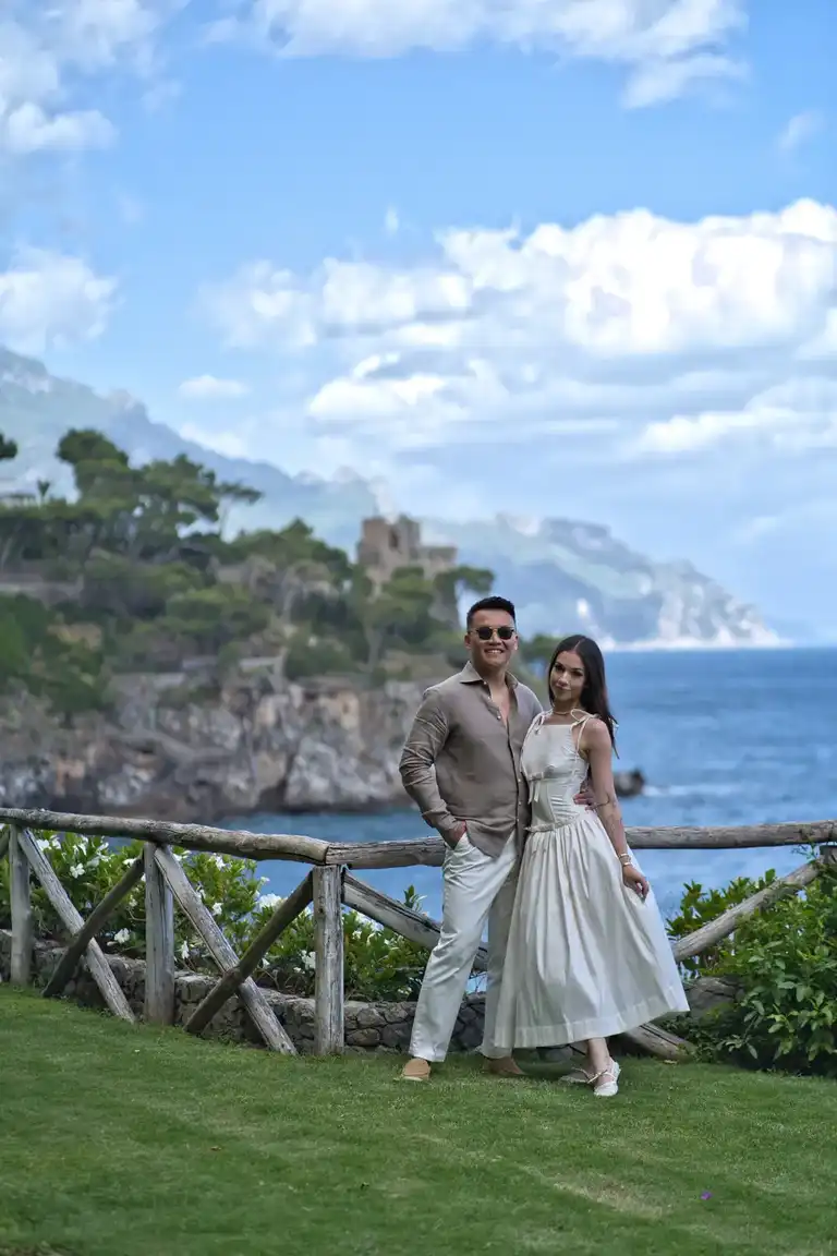 A close-up of the bride and groom sharing a loving look and embrace, standing against the rugged, sheer cliff face that characterises the setting of Borgo Sant'Andrea near Amalfi.