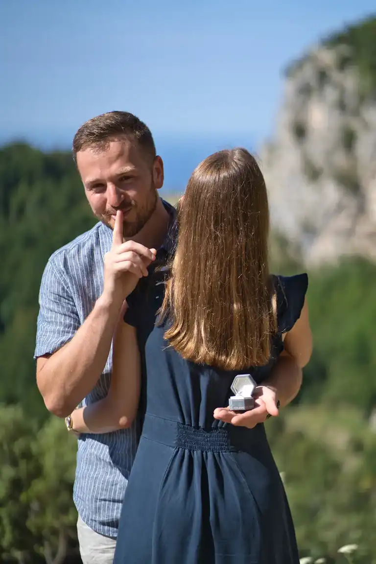 Close-up candid portrait of newly engaged couple laughing and celebrating on the Path of the Gods near Bomerano at sunrise, Amalfi Coast engagement photography.