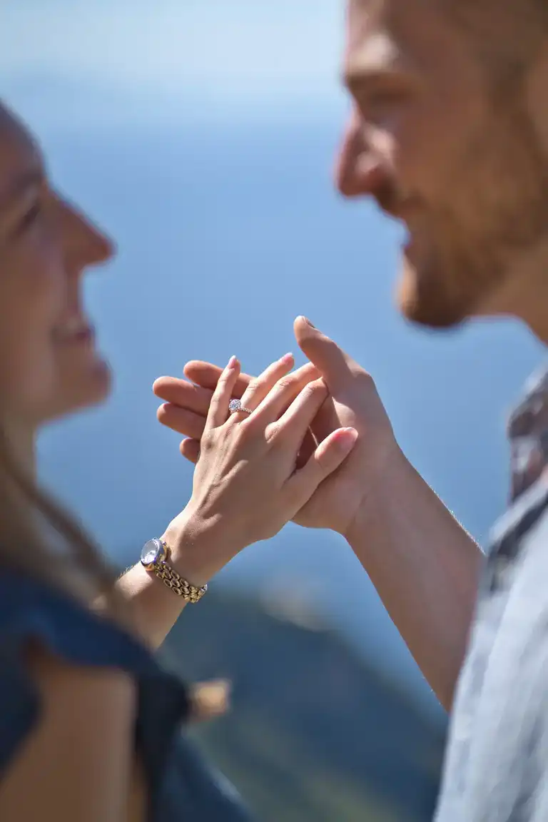 Portrait of a newly engaged couple embracing and laughing on the Path of the Gods near Bomerano at sunrise.