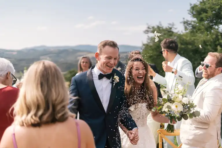 bride and broom walk out the isle after the ceremony smiling