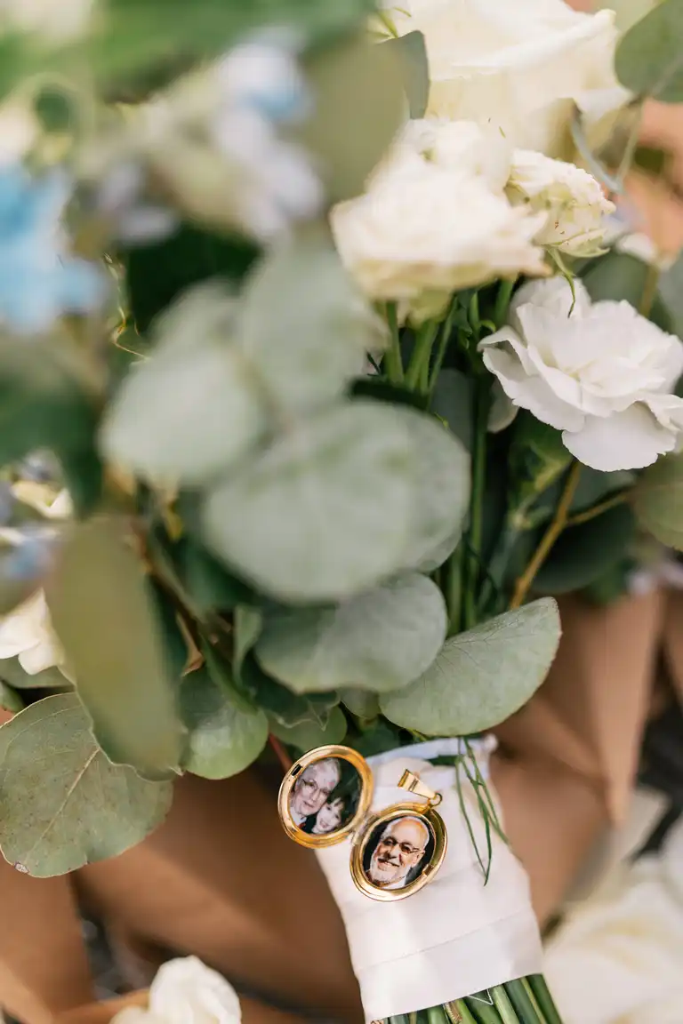details of wedding bouquet with charm containing pictures of parents