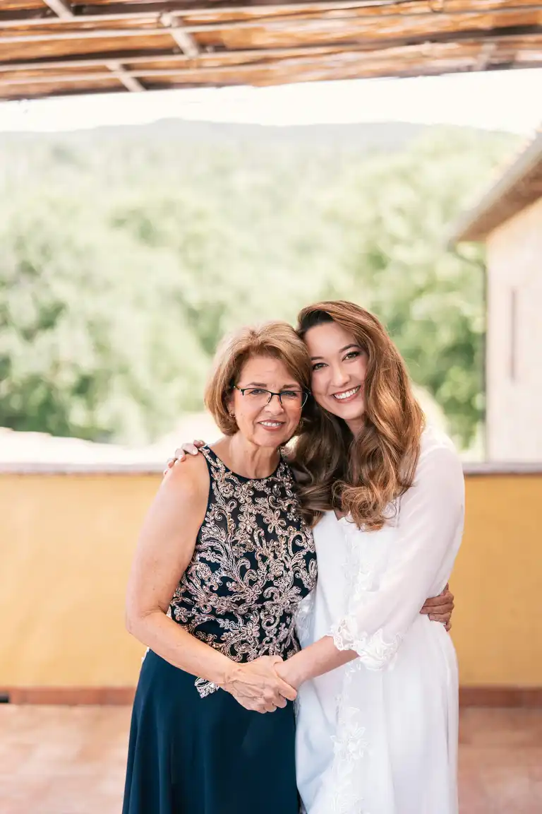 Bride getting prepared take a picture with her mom
